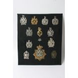 A collection of 13 various Kings Own Scottish Borders badges of various sizes,