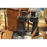 A pair of leather cased binoculars, A. G. Co ltd.