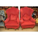 Two wing armchairs in red upholstery.