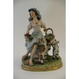 A Capodimonte figure of a girl with two goats and holding flowers in the folds of her skirt.