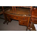 An oak desk with a leather inset top above draws on turned legs