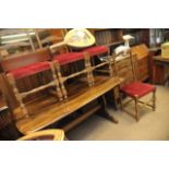 A dark wood Ercol table and four ladder back chairs.