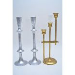 An adjustable triple sconce brass candlestick having narrow rod supports and shaped flared sconces