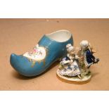 A ceramic blue glazed and hand painted clog and a 20th century Porcelain figure group.