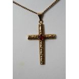 An 18ct gold cross with attached 9ct gold chain