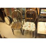 A set of 8 wheel back chairs,