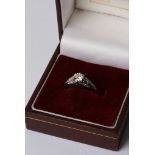 An 18ct gold diamond ring with white gold shank