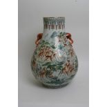 A Chinese Republic type vase of Hu shape profusely decorated with deer in a natural setting having