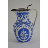A decorative Victorian blue and white jug with pewter lid and spout.