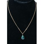 A malachite pendant with attached 9ct gold chain