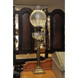 A brass oil lamp with Corinthian column base.