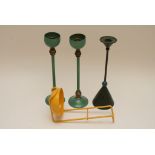 A group of modern design items comprising a pair of green and gold metal candlesticks with raised