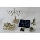 A small group of silver plated items comprising a novelty condiment set in the form of an open top