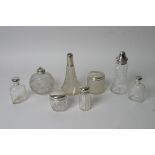 A collection of eight silver topped glass bottles