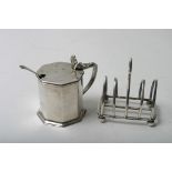 A silver mustard pot and a small toastrack