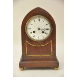 An Edwardian Walnut arch top mantel clock with French movement.