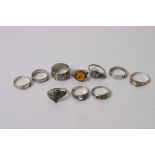 A collection of silver and white metal rings.