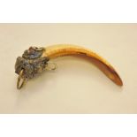 A metal mounted hog tusk