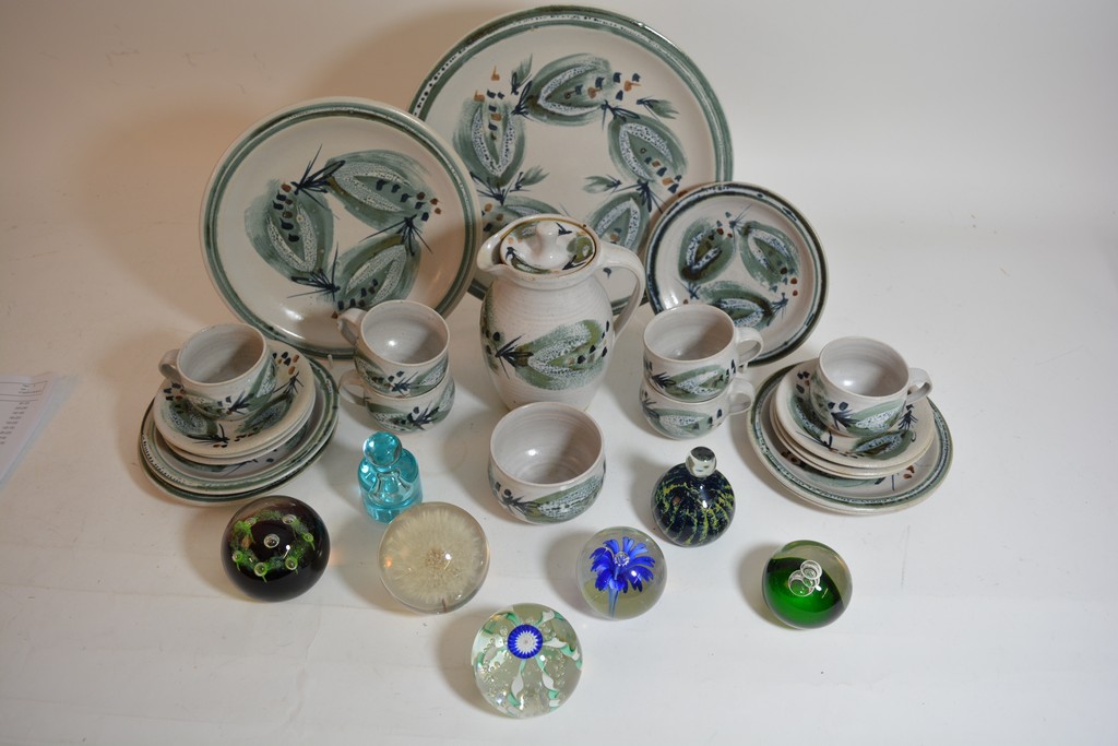 Seven glass paperweights together with a collection of St Ives pottery items.