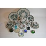 Seven glass paperweights together with a collection of St Ives pottery items.