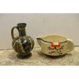 A Clarice Cliff 'Ravel' pattern jug and  a Doulton Lambeth jug with incised leaf decoration,