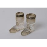 A pair of silver rimmed glass boots