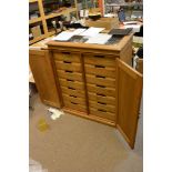 A bespoke fine quality pine collectors cabinet with a glass open lid top with two doors concealing