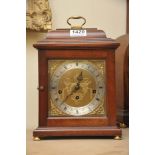 A modern reproduction Mahogany mantle clock.