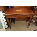 A Georgian inlaid card table on turned and cabriole legs.