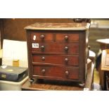 A mahogany apprentice chest, the rectangular top above two short and three long drawers,