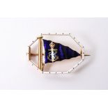 A rare 18ct gold and enamel Benzie of Cowes brooch in the form of a Royal blue flag with applied