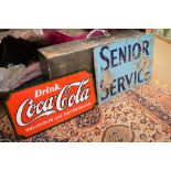 An enameled metal Coca Cola sign and an aluminium senior service sign