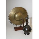 A gong on stand and middle eastern type metal ewer