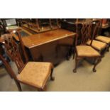 A set of four Mahogany dining chairs with ball and claw feet and a conforming drop leaf table.
