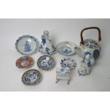 A collection of blue and white ceramic items including a musical figurine,