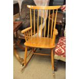 A set of four ercol dining chairs and a stick back rocking chair