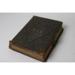 A leather bound Victorian photograph album and contents.