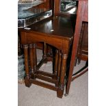 A nest of three oak occasional tables with rectangular tops