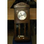 An Edwardian oak cased wall clock.