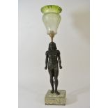 A vintage bronze table lamp in the form of an Egyptian figure on a marble base with an etched green