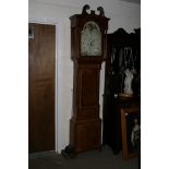 An eight day oak longcase clock with moon face dial signed Th.S.