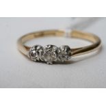 An 18ct gold ring with three old cut diamonds.