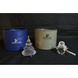 Two boxed Swarovski crystal ornaments comprising a snowman and Christmas tree