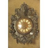 A 19th century Black Forest carved oak wall clock the case with a raised boars head