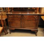 A Mahogany sideboard with two drawers over two cupboard doors and raised on pad feet.