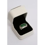 A 18ct white gold ring inset with jade stone surrounded by diamonds with testing certificate.