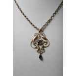 A gold necklace with Art Nouveau style pendant drop