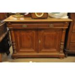 A 19th Century carved walnut side cabinet fitted with two drawers and cupboards underneath