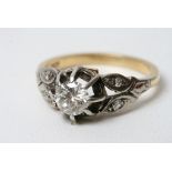 Withdrawn An 18ct gold ring set with a single diamond and diamond chip shanks