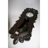 A carved black forest wall clock,